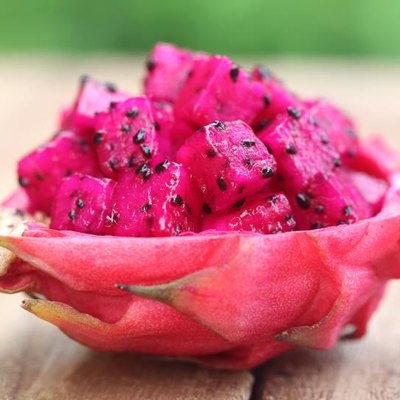 Pieces of dragon fruit on wooden surface