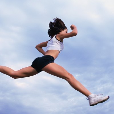 Woman in full stride, jumping