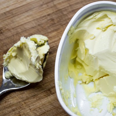 Scooping Butter/Margarine from a Tub High-angle View