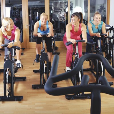 Beautiful women doing exercise in a spinning class at gym