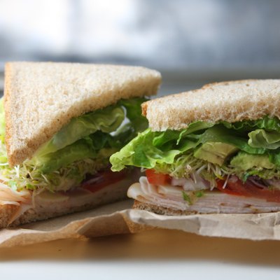 Healthy turkey avocado and sprouts sandwich on whole wheat lunch