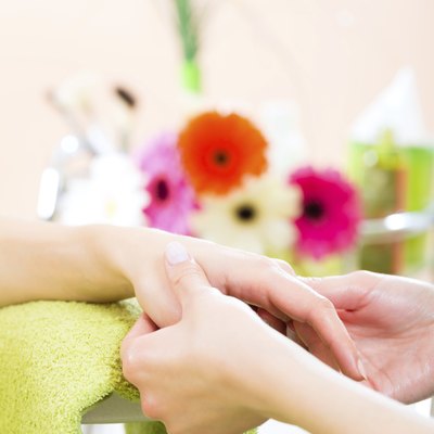 Woman in nail salon receiving hand massage