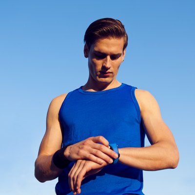 Handsome athlete checking pulse