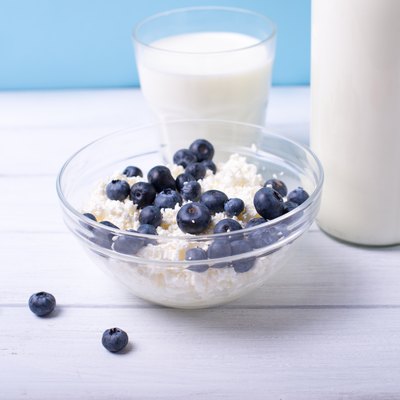 Fresh dairy products with blueberry on wooden table
