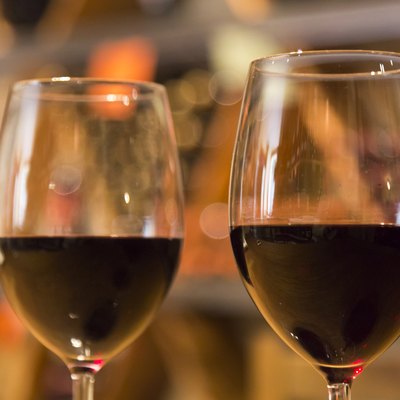 Line of two wine glasses full of wine