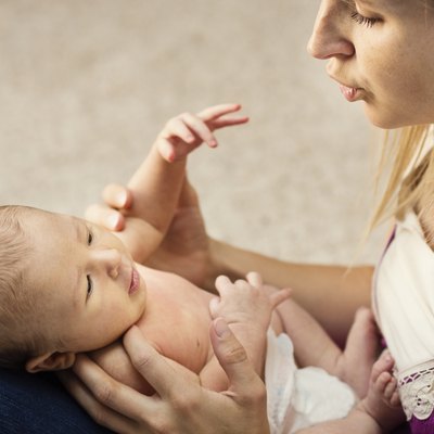 Mother caring for small baby