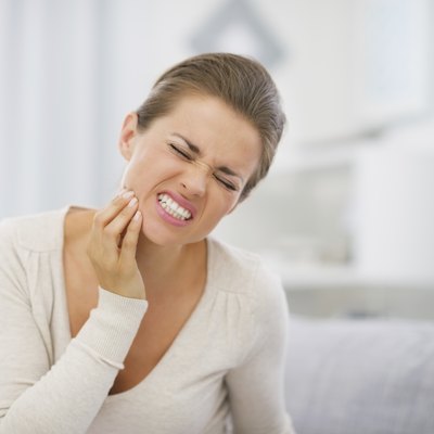 portrait of young woman with toothache