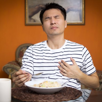 Asian man has a Heart attack symptoms while eating