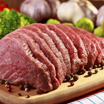 Raw beef and vegetables on wood