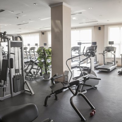 Large, bright gym with workout equipment.