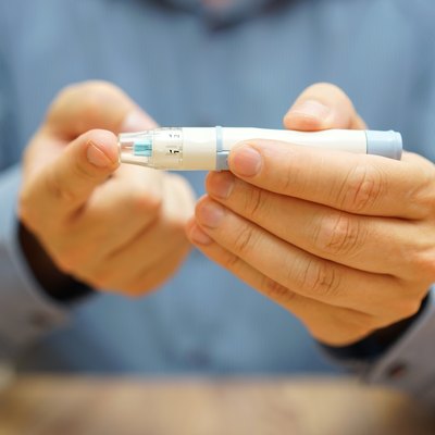 man is measuring the level of glucose in the blood