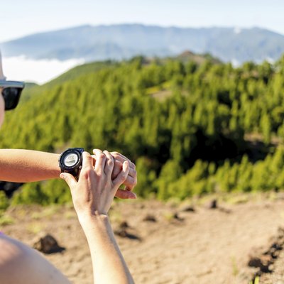 Cross country runner looking at sport watch