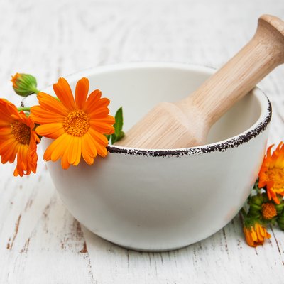 flower of calendula officinalis in mortar