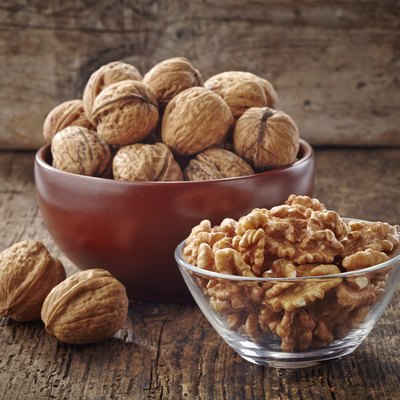 various kinds of walnuts on old wooden table