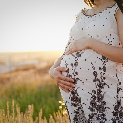 Pregnant girl dressed on the field