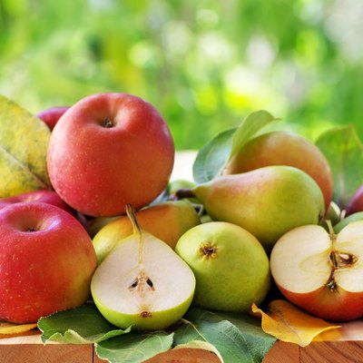 pears and apples on a rustic wooden table
