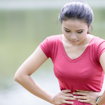Young beautiful woman is having stomach ache