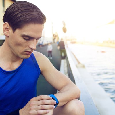 Handsome athlete checking pulse