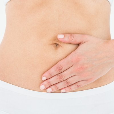 Fit woman touching her painful stomach