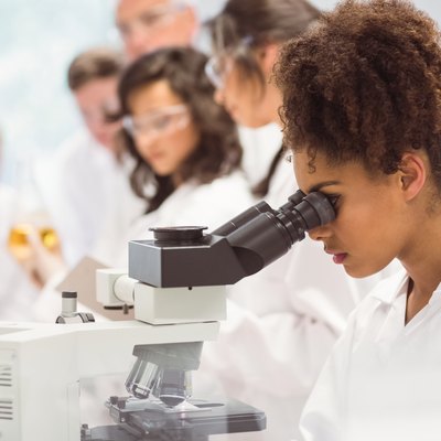 Science student looking through microscope in the lab