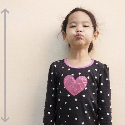 Little girl trying to be taller