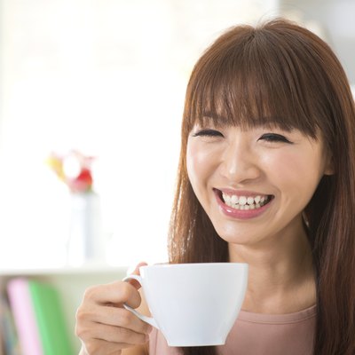 Asian woman enjoying coffee