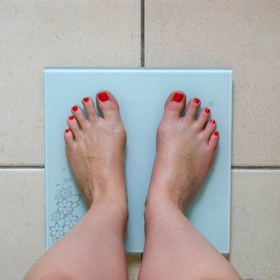 Woman weighing herself