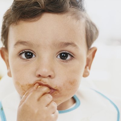 Close-up Portrait of a Boy Toddler Eating