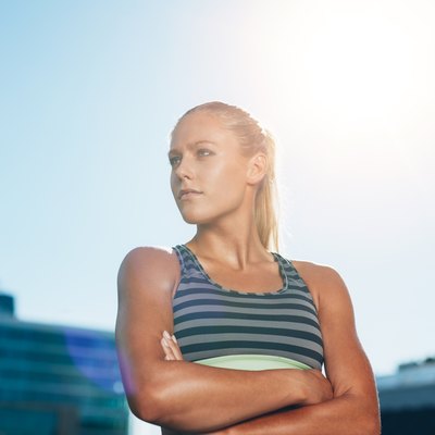 Muscular female athlete in outdoors stadium