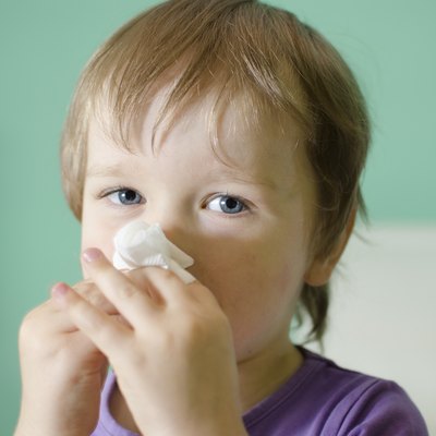 Little boy cleaning nose