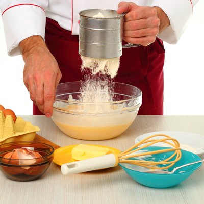 Sifting flour into batter