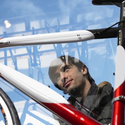 Man looking at bicycle, low angle view through glass