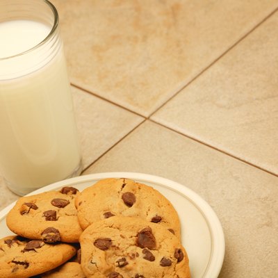 Cookies and glass of milk on work surface