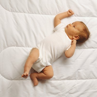 Baby (3-6 months) lying on bed