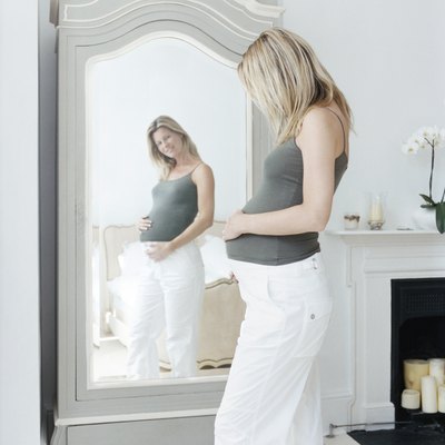 Pregnant Woman Looking at Her Reflection in a Mirror