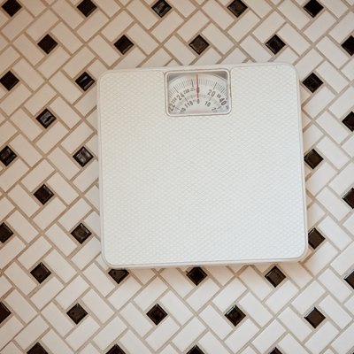 Bathroom scales on tiled floor