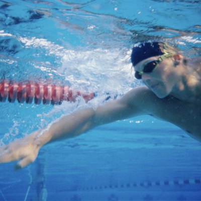 Low angle view of a young man swimming underwater in a swimming pool