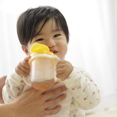 Baby girl drinking from bottle