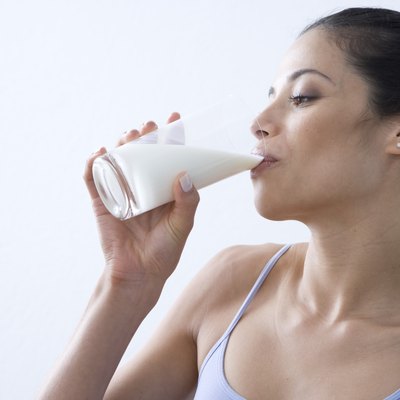 Young woman drinking glass of milk