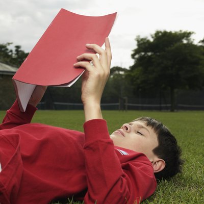 Boy with a notebook in park