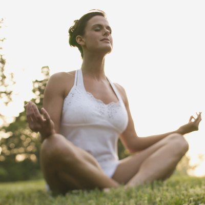 Woman meditating outdoors