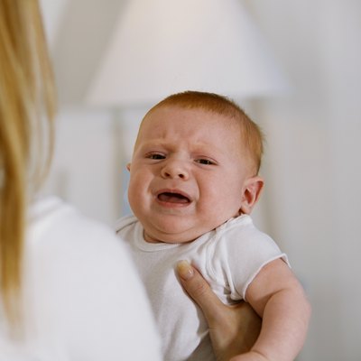 Mother holding crying baby
