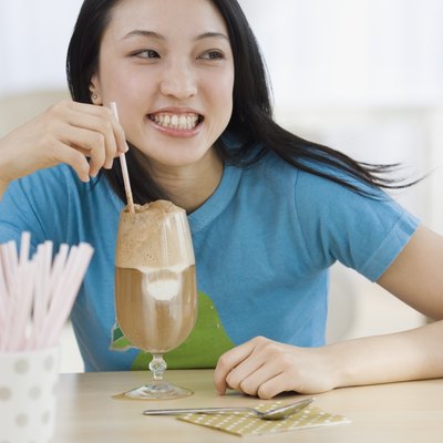 Asian woman drinking milkshake