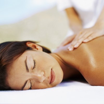close-up of a young woman getting a back massage from a massage therapist