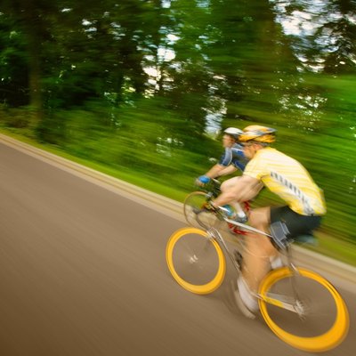 Two people racing on bikes