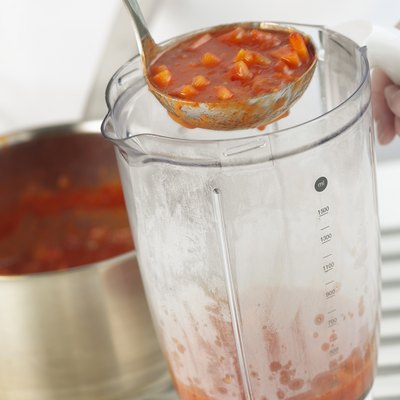 Ladling soup in to a blender, close up