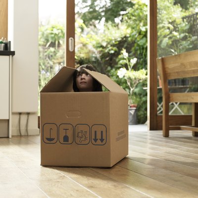 Child in cardboard box