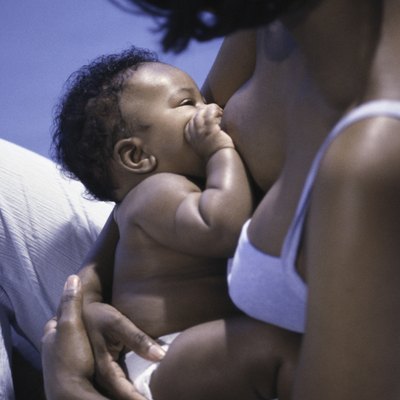 High angle view of a mother breastfeeding her baby boy