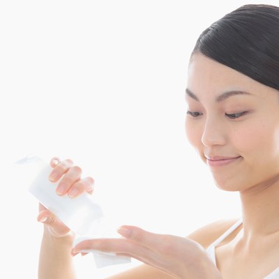 Woman pouring lotion in hand