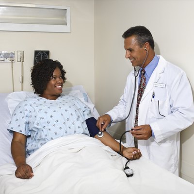 Doctor taking patient's blood pressure